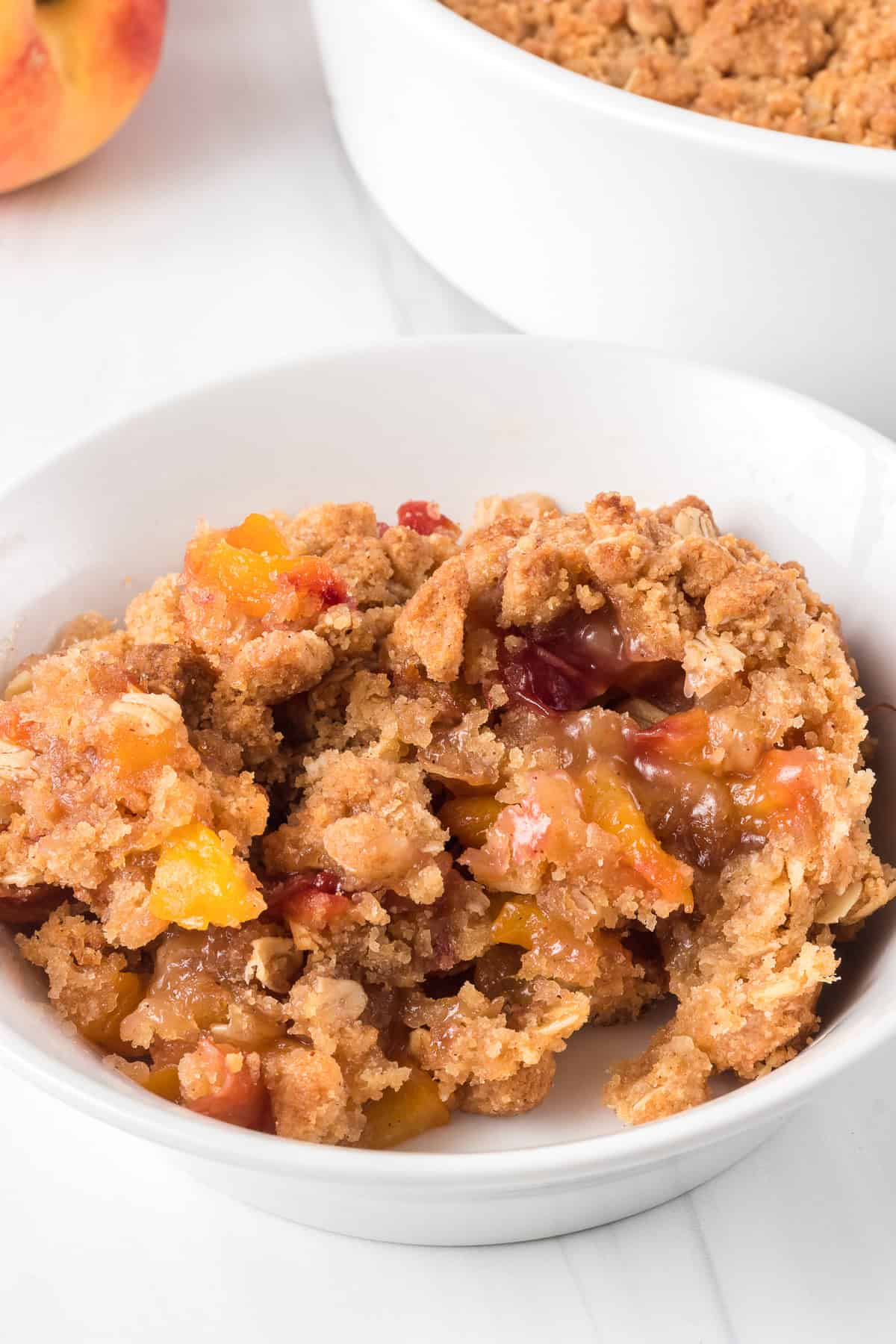 A crisp made with peaches in a bowl.