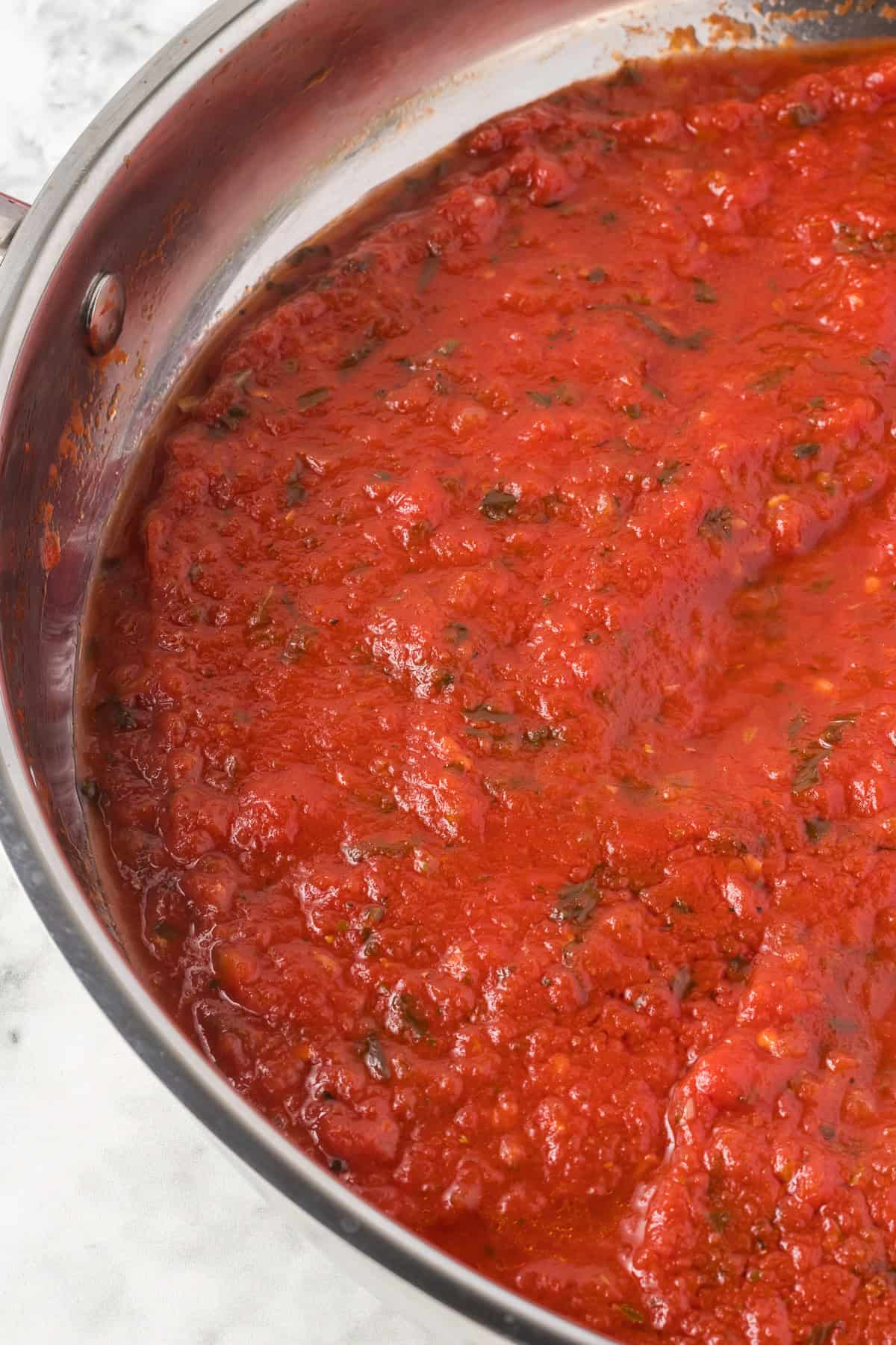 Red Sauce with lots of flavorful spices in a pan.