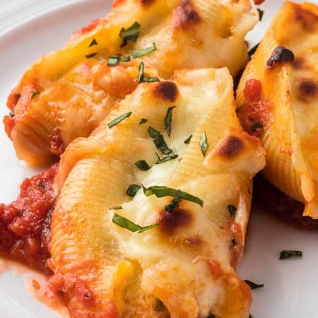 Three Stuffed Shells with Ricotta on a plate.