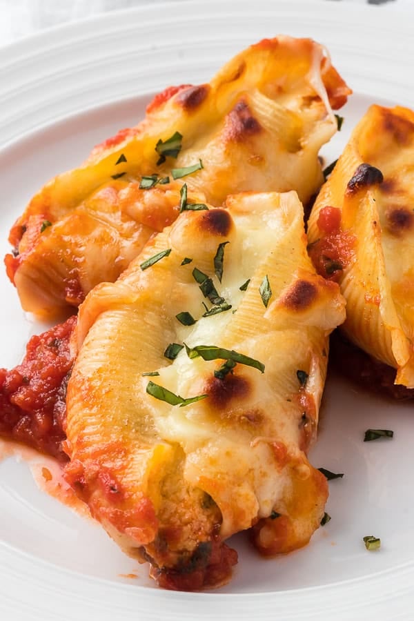 Three Stuffed Shells with Ricotta on a plate.